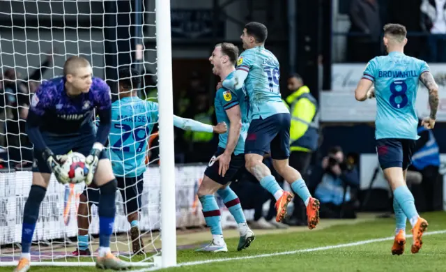 Burnley celebrate Ashley Barnes' winning penalty at Luton last season