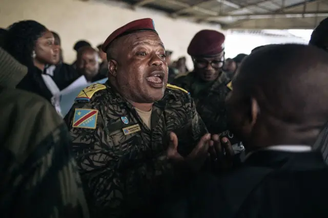 Colonel Mike Mikombe (C), one of the accused Republican Guard officers, argues with a lawyer after the hearing at the military court of Goma, eastern Democratic Republic of Congo, on September 6, 2023.