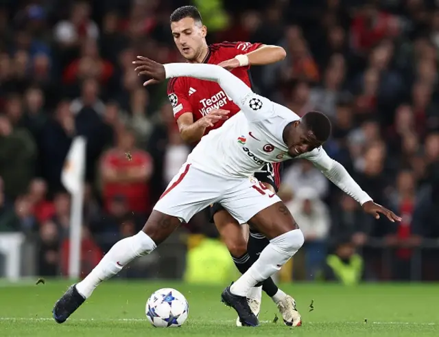 Manchester United's Portuguese defender Diogo Dalot vies with Galatasaray's Ivorian forward Wilfred Zaha