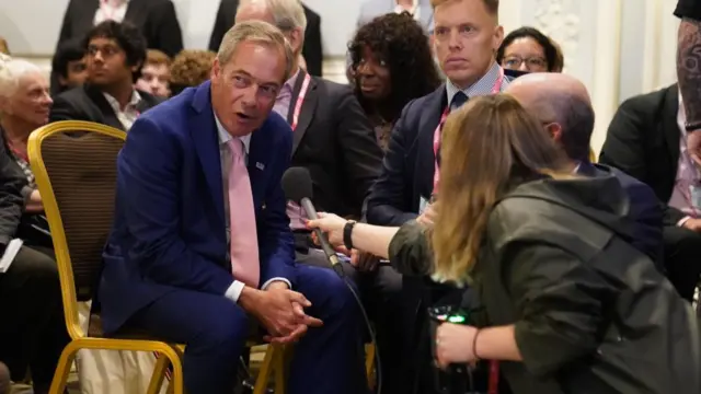 Nigel Farage being interviewed during the Conservative Party annual conference at the Manchester Central convention complex