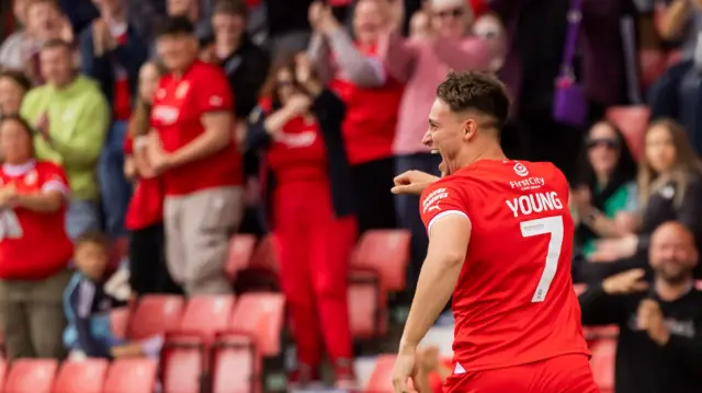 Jake Young celebrates scoring a goal for Swindon