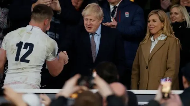 Boris Johnson shakes hand with rugby player at the England v Wales Six Nations rugby international on 7 March 2020