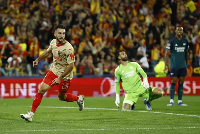 Adrien Thomasson  runs off after scoring, Raya in the background