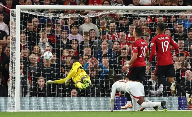 Wilfred Zaha  scores the equalising goal as Onana dives to attempt to save it