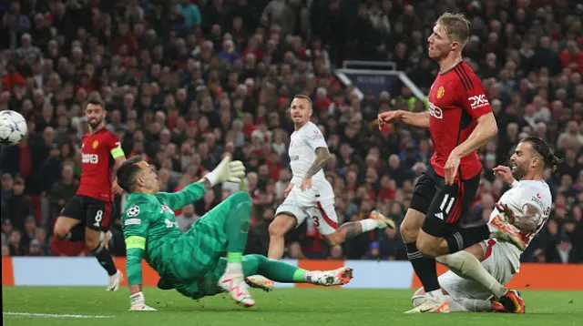 Rasmus Hojlund of Manchester United scores their second goal as Davison Sanchez slips