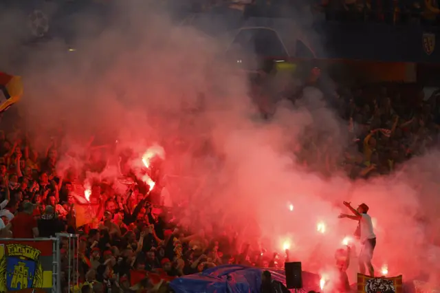 Lens fans let off flares in the stadium