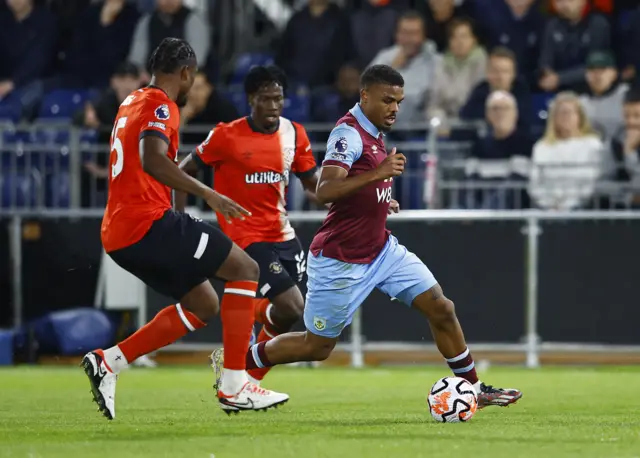 Lyle Foster in action with Luton Town's Issa Kabore