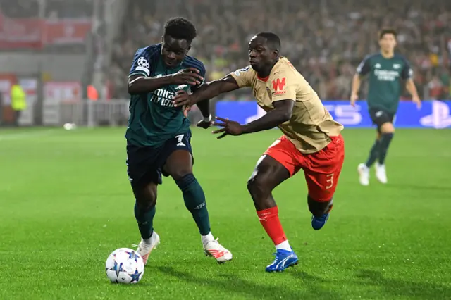 Bukayo Saka of Arsenal is put under pressure by Deiver Machado