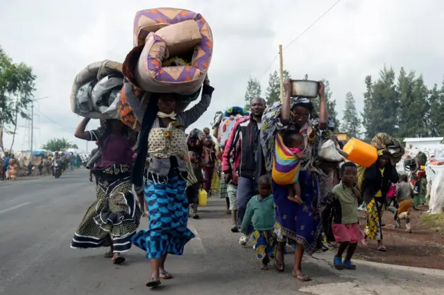 Congolese internally displaced civilians carry their belongings as they flee from renewed tensions from Kanyaruchinya to Goma in the North Kivu province of the Democratic Republic of Congo November 15, 2022