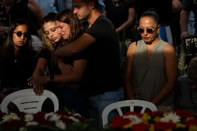 Raz Itamari grieves during the funeral of Lili Itamari, 63, and Ram Itamari