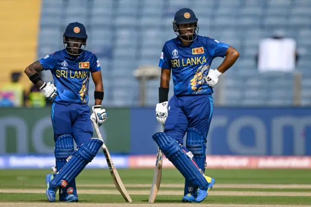 Dimuth Karunaratne and Pathum Nissanka watch on during a review