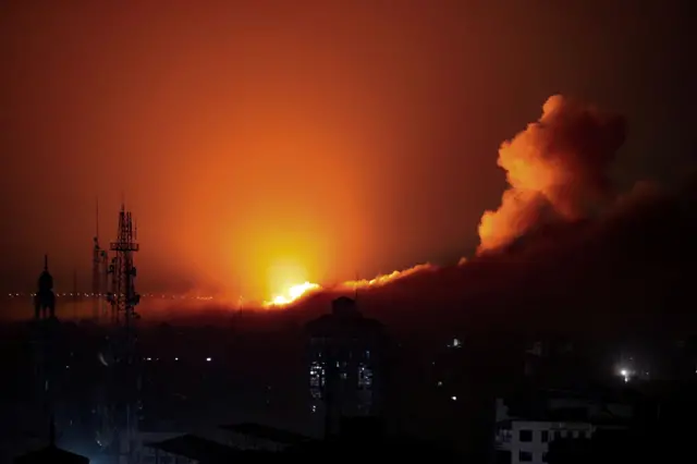 Smoke and flames rise during an Israeli air strike on west Gaza, October 30, 2023.