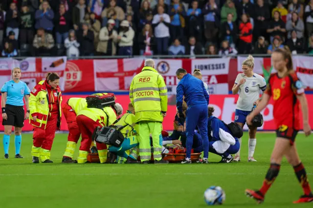 Alex Greenwood receiving medical attention