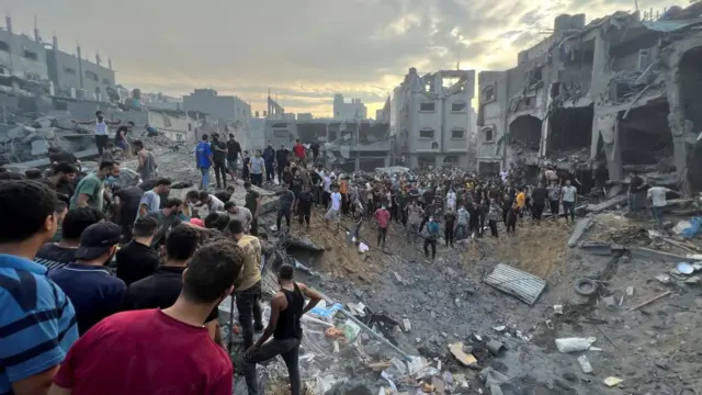 Palestinians search for casualties at the site of a blast