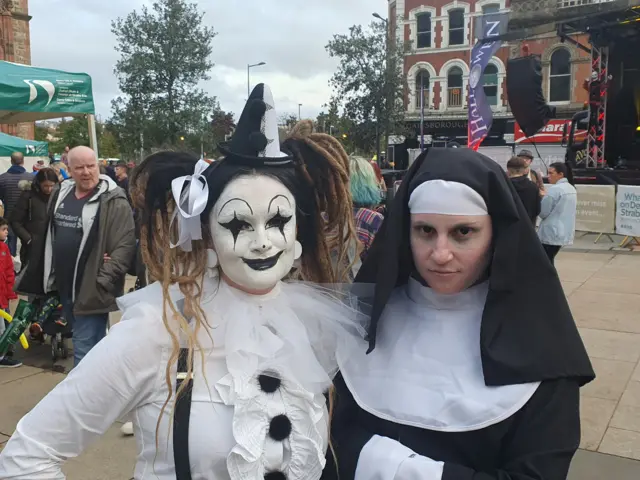 Show two girls from Scotland dressed as a nun and a clown