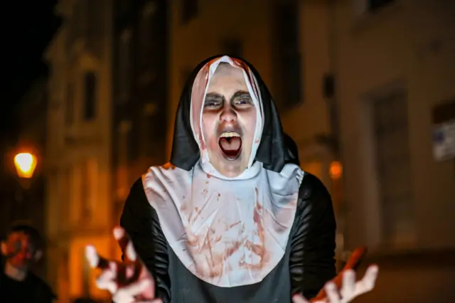 A nun screams at the camera