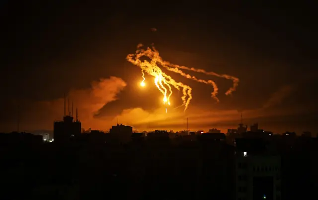 A lighting flare, fired by Israel forces in the sky, is viewed in the northwest of Gaza on October 31, 2023. (Photo by Ali Jadallah/Anadolu via Getty Images)