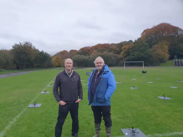 Shows Mark Wingad and Nigel Lelew with some of their drones