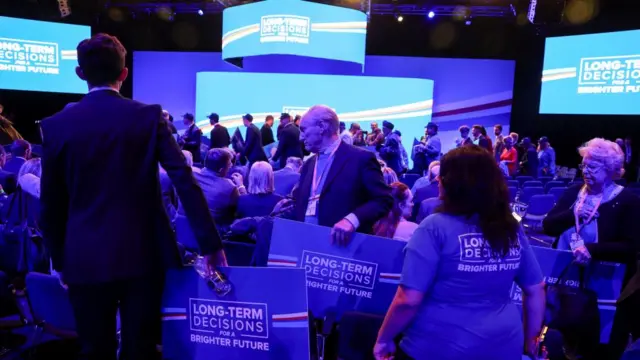 Audience members walk in ahead of the leaders' speech, at the Britain's Conservative Party's annual conference in Manchester, Britain, October 4, 2023.