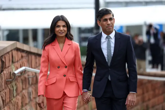 Akshata Murty and Rishi Sunak walk into conference