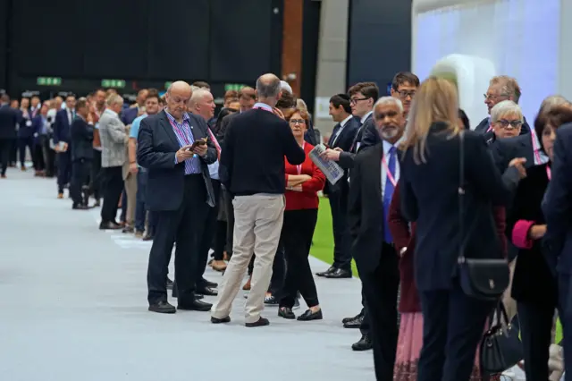 People queue for the auditorium at Conservative Party conference