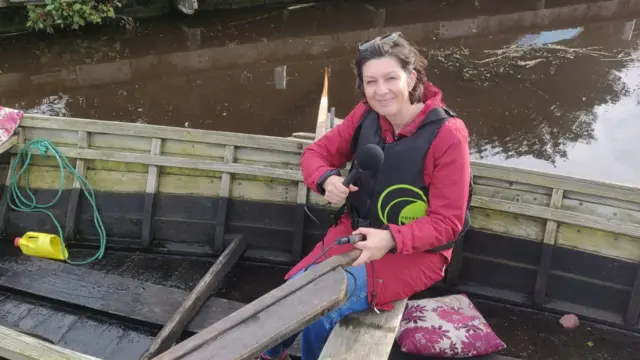 BBC reporter Julie McCullough in a traditional rowing cot on Lough Neagh