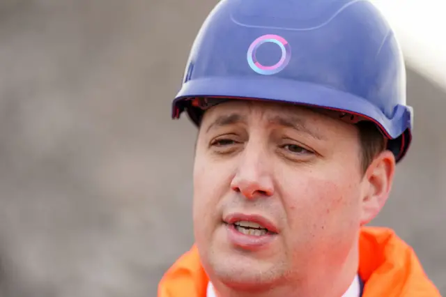 Ben Houhen wears orange hi-vis and a blue hard hat