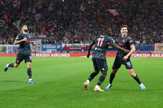 Julian Alvarez of Manchester City celebrates with teammate Jeremy Doku