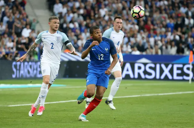 Kieran Trippier and Kylian Mbappe compete for the ball during a friendly match between England and France in 2017