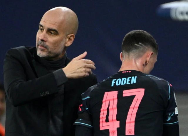 Pep Guardiola on the touchline with Phil Foden