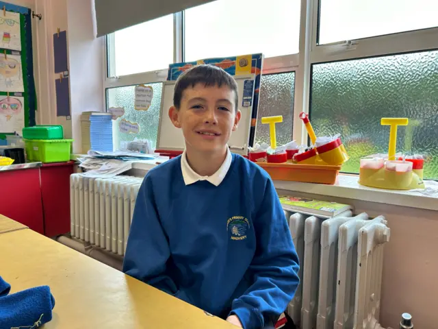 Fionn, a boy in school uniform jumper