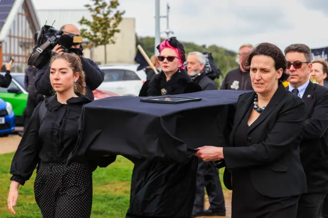 Environmental campaigners carry a coffin signifying Lough Neagh at a "wake" for the lake in September