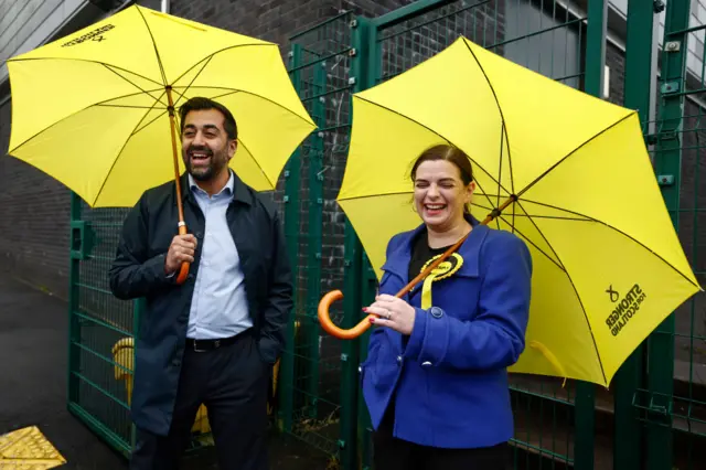 First Minister Humza Yousaf and SNP candidate Katy Loudon braved stormy weather as the tried to secure late votes