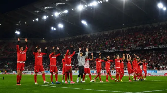 SC Freiburg players celebrate with fans