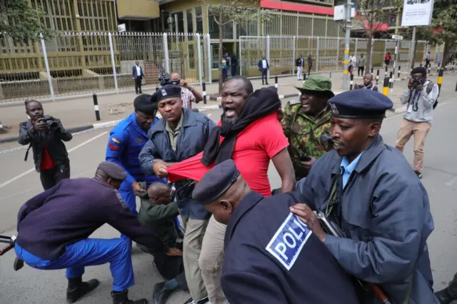 Police officers arrest activists during a demonstration against the high cost of living within the Nairobi's capital. They are demanding that the government should lower the prices of food and commodities.