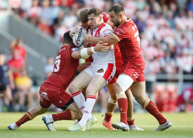 St Helens and Catalans players battle in their match in July