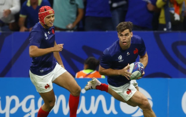 Damian Penaud runs with the ball and Bielle-Biarrey pictured in the background