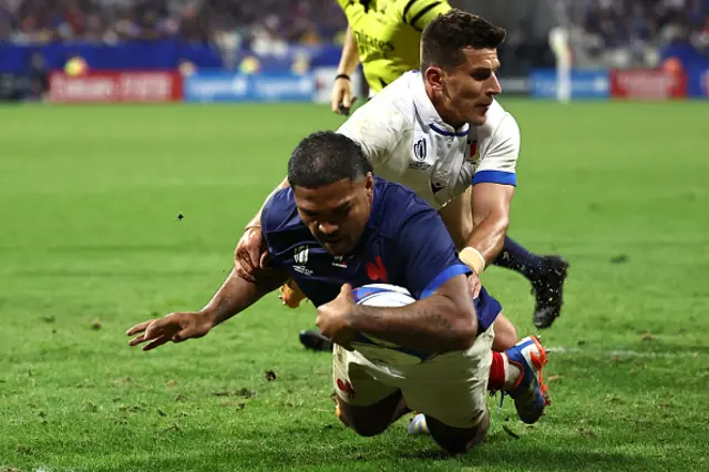 France's hooker Peato Mauvaka dives over the line to score as Tommaso Allan attempts to stop him