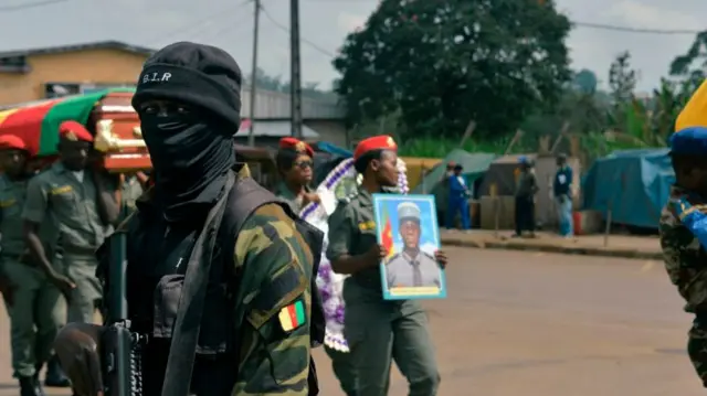 A soldier from the Rapid Intervention Battalion (BIR), provides security at a ceremony honouring four soldiers killed in after violence that erupted in the Northwest and Southwest Regions of Cameroon, where most of the country's English-speaking minority live, in Bamenda on November 17, 2017.