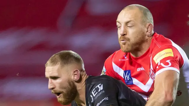 St Helens' James Roby tackles Sam Tomkins of Catalans Dragons in a match in November 2020