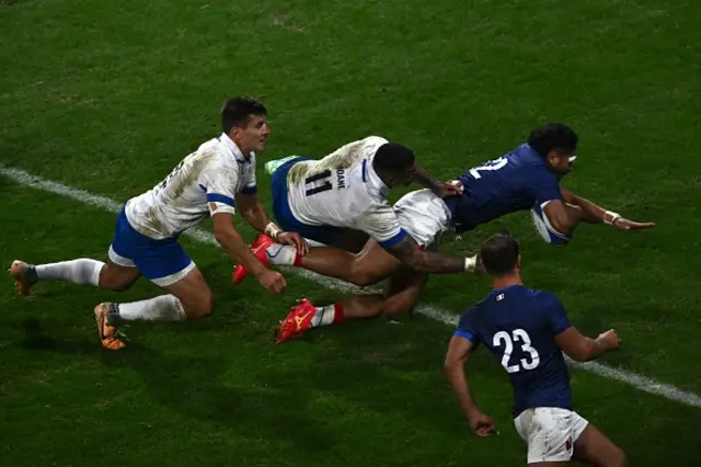 France's centre Yoram Moefana  dives across the line