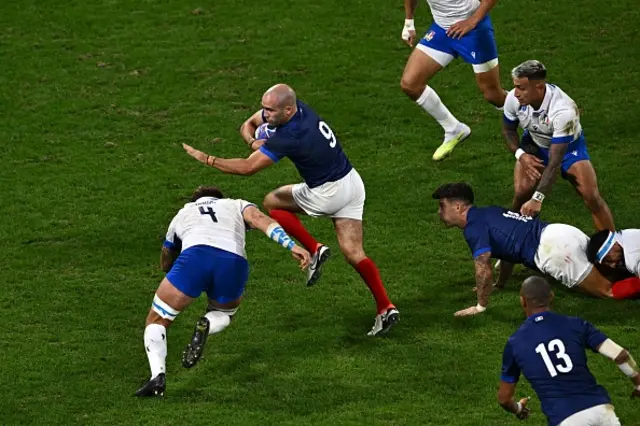 Maxime Lucu runs with the ball as he is tackled by Italy's lock Niccolo Cannone