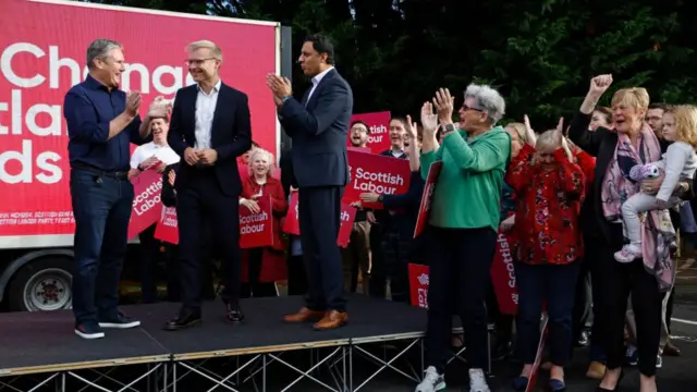 Keir Starmer, Anas Sarwar and a crtowd of Labour activists clap and cheer Michael Shanks