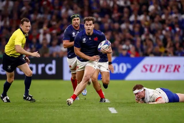 Damian Penaud of France runs with the ball