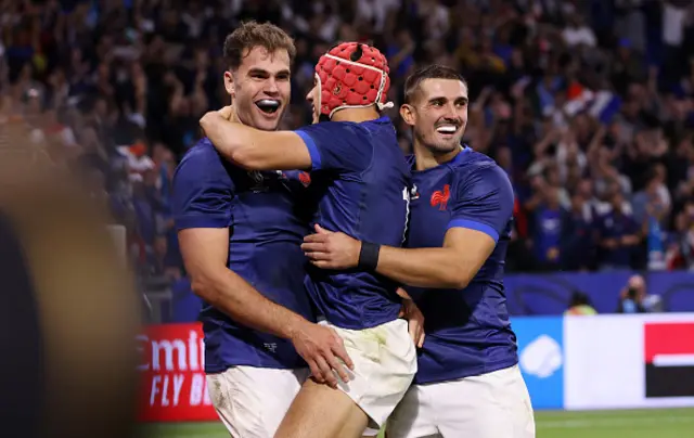 Damian Penaud of France celebrates with Louis Bielle-Biarrey and Thomas Ramos