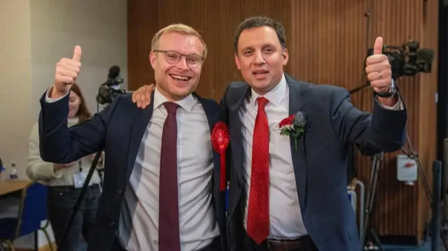 Michael Shanks and Anas Sarwar arm in arm, with their thumbs up