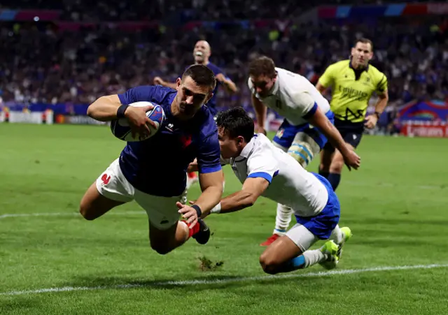 Thomas Ramos of France dives in the corner past Capuozzo to score