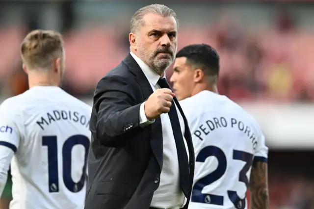 Ange Postecoglou fist pumps towards the travelling fans.