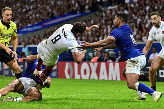 England's scrum-half Alex Mitchell is tackled by Samoa's scrum-half Jonathan Taumatein