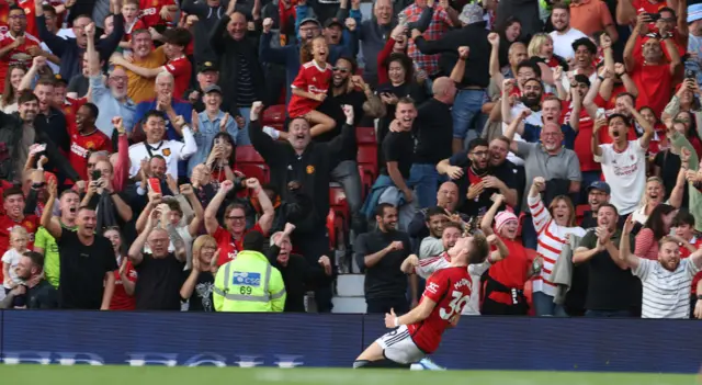 McTominay slides on his knees in front of the United fan.